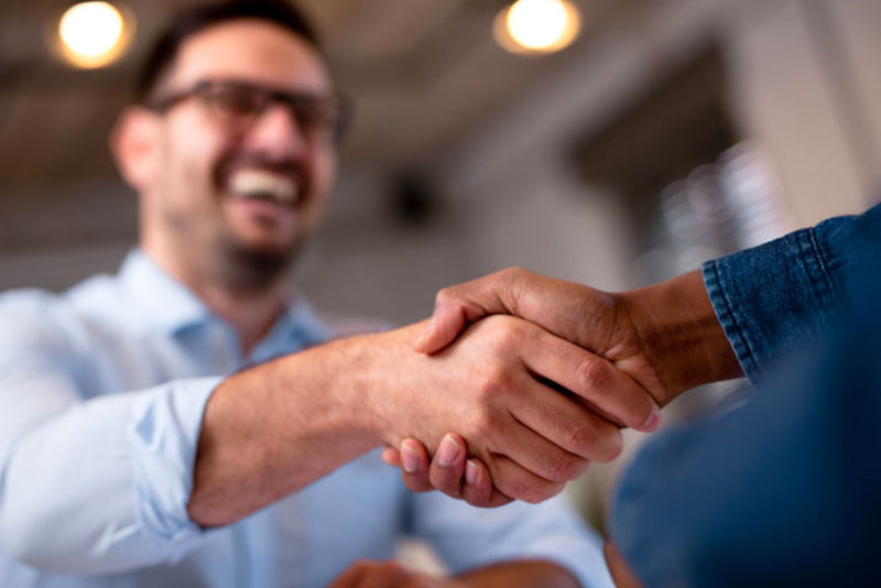 handshake between patient and dental staff