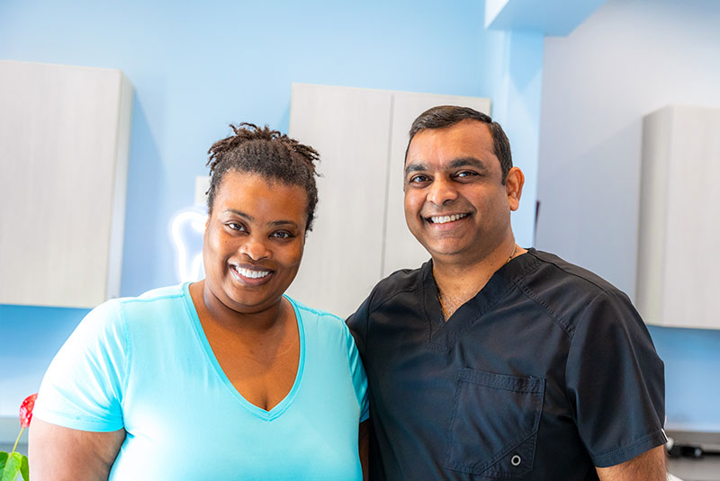patient and doctor taking picture together within the dental practice